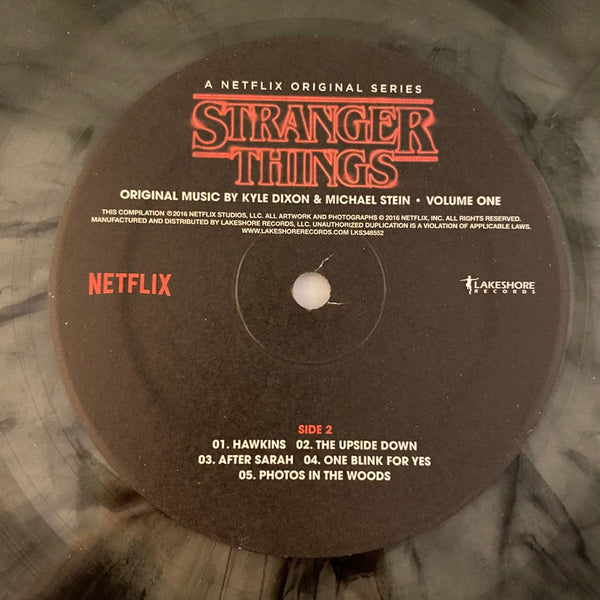 Used Vinyl Kyle Dixon, Michael Stein – Stranger Things - Volume One 2LP USED NM/NM Clear Black Smoke Vinyl J061823-04